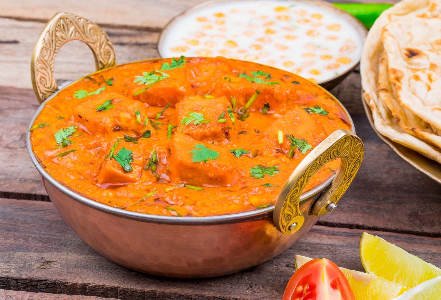 Delicious Indian paneer curry in creamy tomato sauce served with naan and rice.
